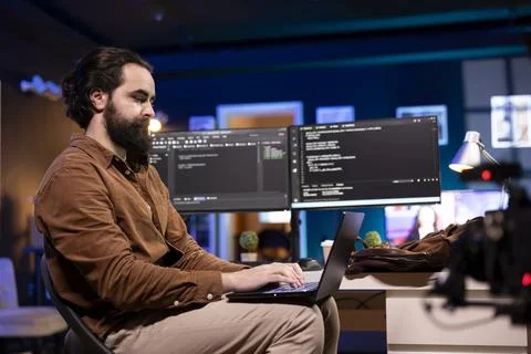 Programmer doing software debugging using laptop, checking errors in code Stock Photos