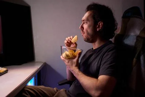 Programmer enjoying late night snack, Individual working alone in home office Stock Photos