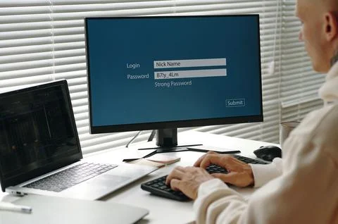 Programmer Entering Password On Computer Stock Photos