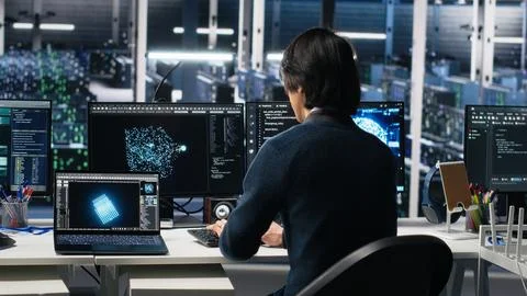 Programmer entering server room office, using AI to review infrastructure Stock Photos