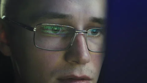 The programmer enthusiastically looks at the computer screen Видео 176414866