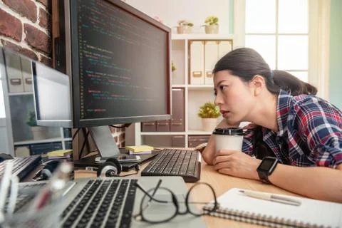 Programmer feeling exhausted and holding coffee Stock Photos