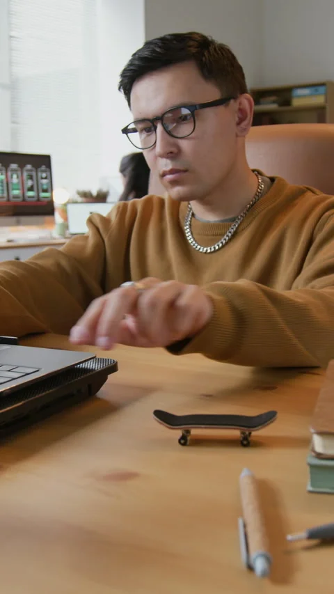 Programmer Fingerboarding while Working in Office Stock Footage 317325122