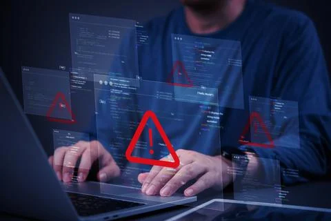 Programmer fixing bugs in code while dealing with error alerts, showing the.. 库存照片