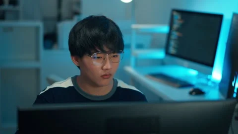 Programmer focusing on monitor for coding task Stock Footage 313808443