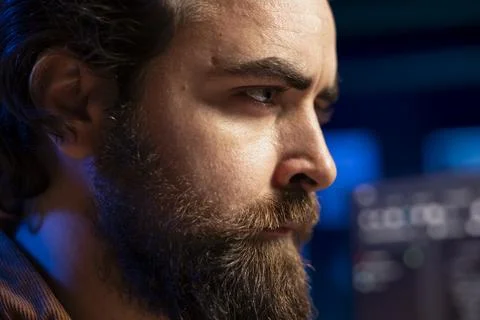 Programmer with frown on face trying to fix software vulnerabilities, close up 스톡 사진