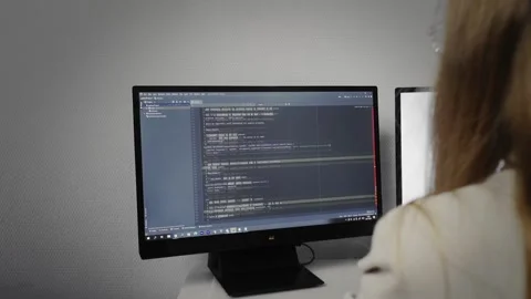 Programmer girl scrolling HTML web page code. Programming Stock Footage 168676175