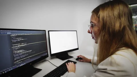 Programmer girl scrolling HTML web page code. Programming Stock Footage 168676313