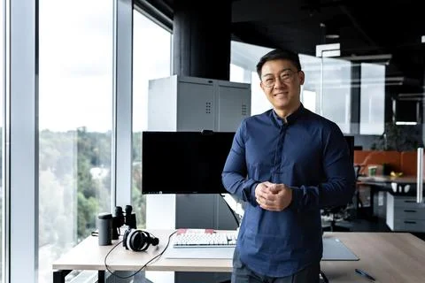 Programmer in glasses and shirt smiling and looking at camera, Asian man working Stock Photos