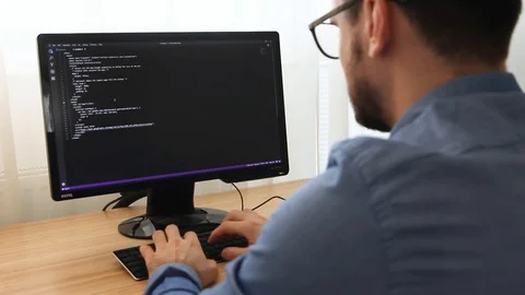 Programmer in Glasses Typing New Lines of HTML Code Stock Footage 106031854