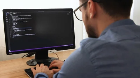Programmer in Glasses Typing New Lines of HTML Code Stock Footage 106031900