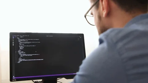 Programmer in Glasses Typing New Lines of HTML Code Stock Footage 106031911