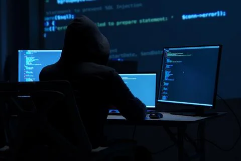 Programmer Hacker Working at Multiple Monitors in Dark Room Stock Photos