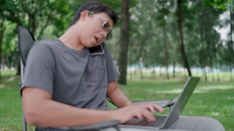 Programmer hand hold smartphone conversation with abroad Stock Footage 283186698