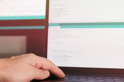 Programmer hands on laptop keyboard Stock Photos