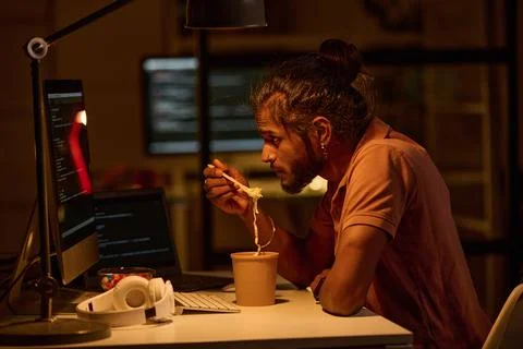 Programmer having lunch at his workplace Stock Photos