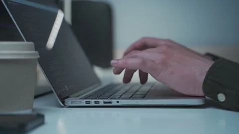 Programmer in headphones cancel noise working on new software development behind Stock Footage 153500150