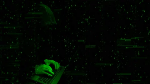 Programmer hiding face typing on computer keyboard, technological green Stock Footage 114908277