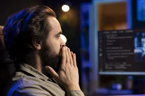 Programmer in home office staggered by AI gaining consciousness 스톡 사진