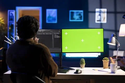 Programmer installing fortified code on chroma key PC to prevent cyber attacks 스톡 사진