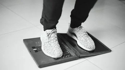 The programmer jumps with his feet in anger on an old laptop that worked slowly Stock Footage 145075279