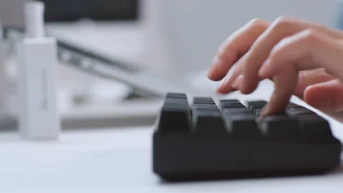 A programmer is knocking on the wireless keyboard in an IT office. 4K Stock Footage 108856811