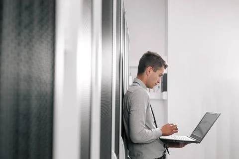  Programmer with laptop in data center room Portrait of modern young man h... 스톡 사진