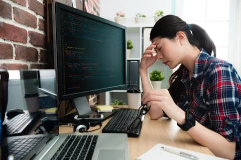 Programmer looking at computer working long time 写真素材