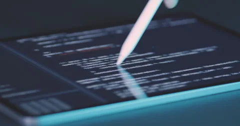 Programmer looks at lines of code of program on tablet screen and moves Video stock 248206479