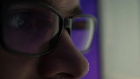 Programmer, a man in front of a computer, the code is reflected in the glasses. Stock Footage 220179568