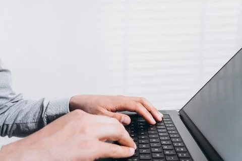 Programmer man hands typing on laptop computer keyboard and surfing the inter Stock Photos
