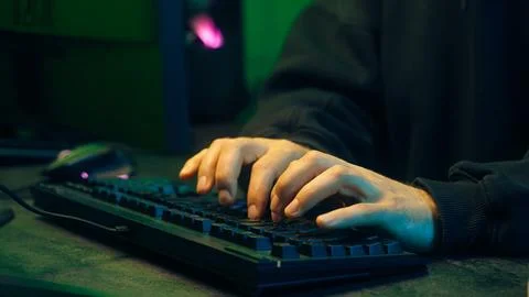 Programmer man keyboard computer typing hacker internet networking online Stock Photos