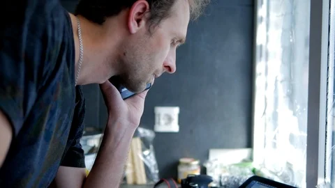 Programmer man tensely working with laptop standing near window with it Stock-Footage 89448939