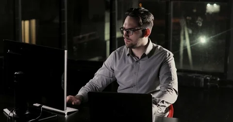 Programmer man is working in the office late at night overtime. Stock Footage 105301636
