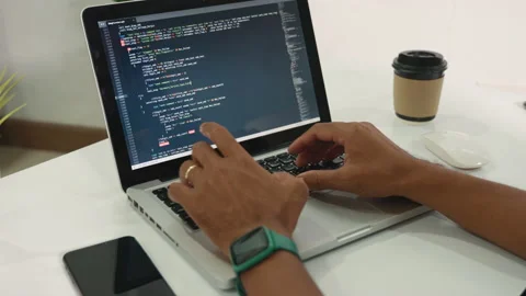 Programmer man writing program code sitting at workplace in office Stock Footage 233589134