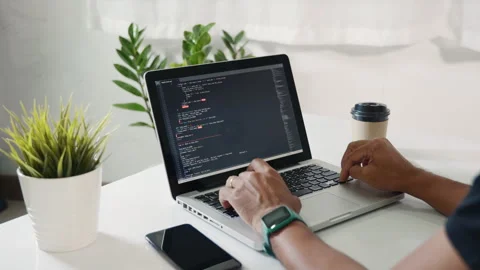Programmer man writing program code sitting at workplace in office Stock Footage 241408919