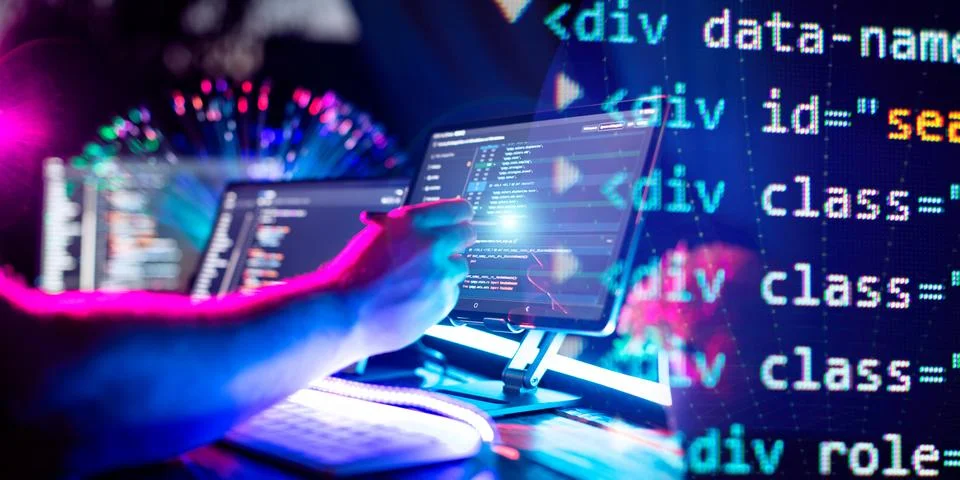 Programmer manually working with program code on a computer at night in a d.. Stock Photos