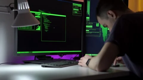 Programmer notes diligently. An attentive programmer captures every detail in Video stock 343902498