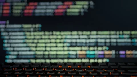 A programmer observes as a computer display dynamically generates precise al Stock Footage 331458841