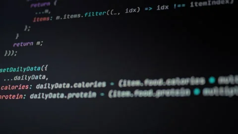 Programmer observes their computer monitor where AI automation algorithms ex Stock Footage 334075698