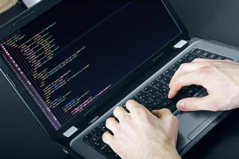 Programmer occupation - writing programming code on laptop Foto stock