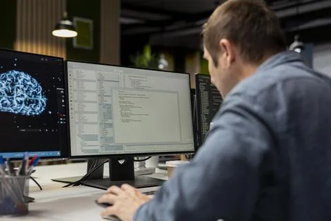 Programmer in office automating repetitive tasks using machine learning Foto stock