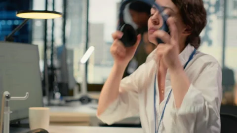 Programmer in office listening music, automating workflows using AI Stock Footage 323144031
