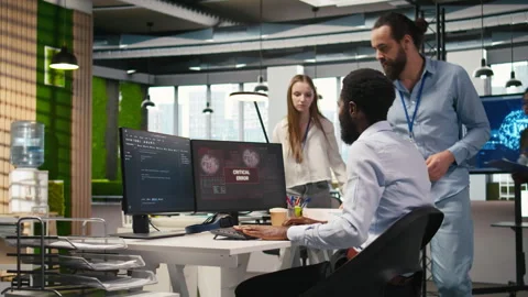 Programmer in office requesting help from coworkers to fix critical error Stock Footage 313018413