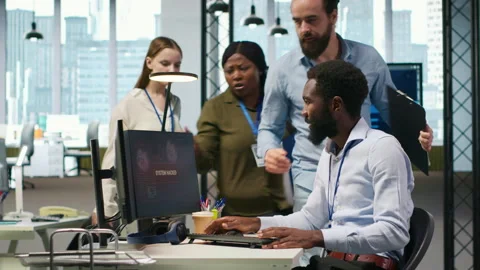 Programmer in office requesting help from coworkers to fix critical error Video stock 313168446