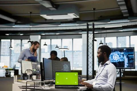 Programmer in office using AI automation scripts on green screen computer 写真素材