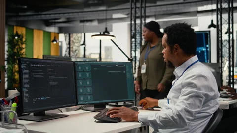 Programmer in office using AI LLM chatbot to get help Stock Footage 323031722