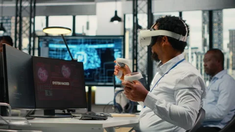 Programmer in office using virtual reality tech to fix hacking attempt Stock Footage 323332573