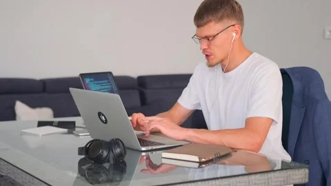 Programmer in online meeting, coding and tackling challenges with team. Stock Footage 299895407
