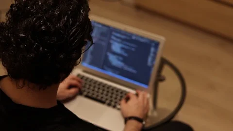 Programmer or Developer coding program on laptop, blurry background Stock Footage 121581583